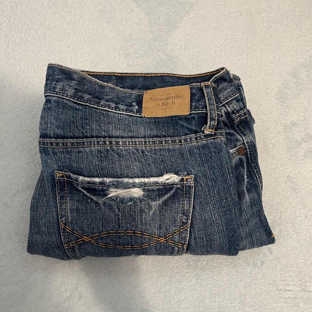 Vintage 90s style low rise ripped jeans.